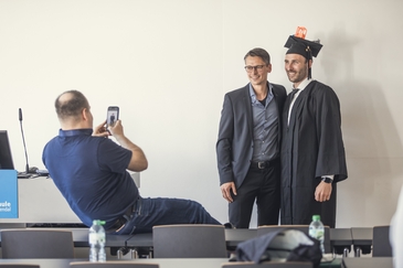 A newly graduated doctoral student celebraA newly graduated doctoral candidate celebrating with his supervisor after a successful disputation at Magdeburg-Stendal University