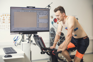 Elektrokardiographie von einer Testperson auf einem Wattbike.