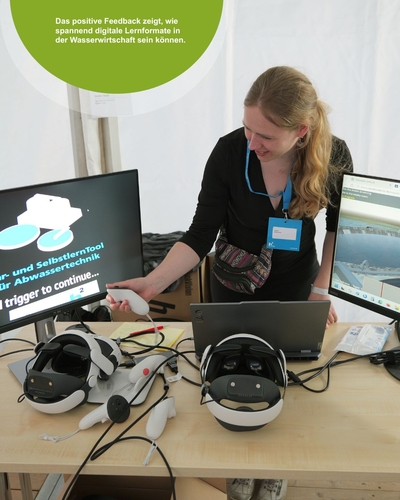 Employee Melina Gross from the wastewater group is standing in front of a table with two VR headsets on it. She is holding a controller and pointing at a screen displaying the text “Self-Learning Tool for Wastewater Technology.”