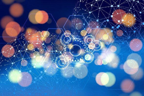 Das Bild zeigt Zahnräder. Der Hintergrund ist bunt und futuristisch.